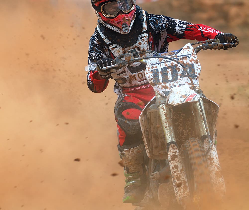 motocross rider in cloud of dust