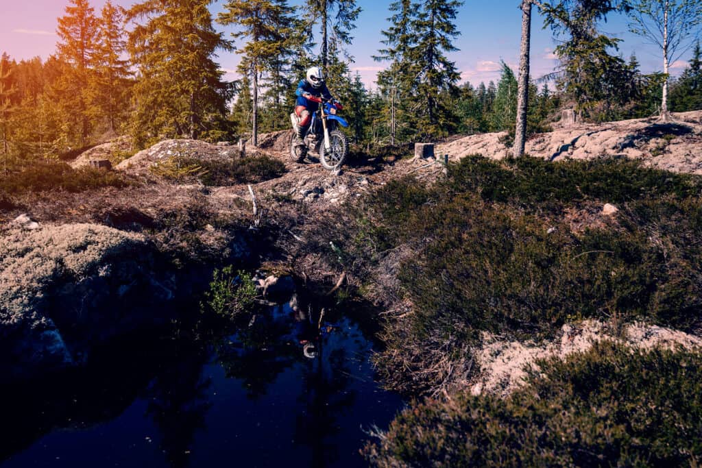 dirt bike in a rocky forest