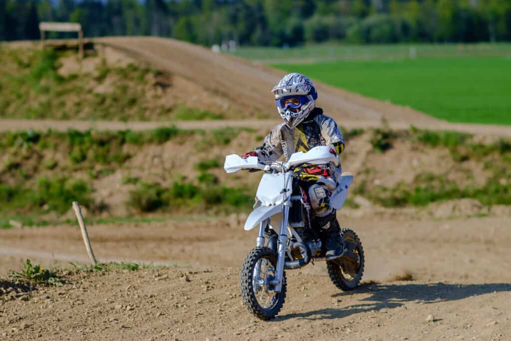 young enduro racer on small hill